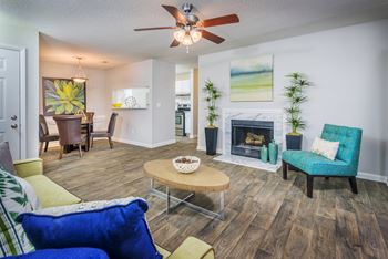 A living room with a fireplace and a blue chair
