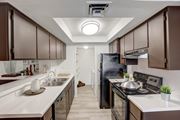 Mesa apartment for rent - a kitchen with dark cabinets and white countertops at Glen at Mesa Apartments, AZ 85201