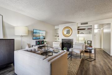 Mesa apartment for rent - A living room with a fireplace and a painting on the wall.