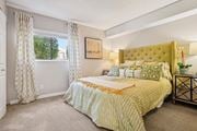 Broomfield apartment for rent - A bedroom with a large bed and a window with curtains. at Deer Crest Apartments, Broomfield, Colorado