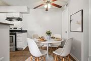 Colorado Springs apartment for rent - A dining room with a table set for two and a fan above. at Windmill Apartments, Colorado Springs, CO, 80916