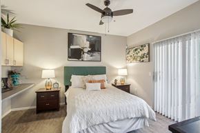 Phoenix apartment for rent - A bedroom with a large bed and a ceiling fan at Sweetwater At Metro North Apartments, Phoenix, AZ