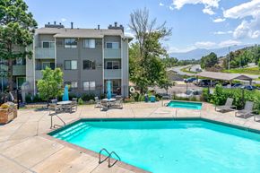 Colorado Springs apartment for rent - Swimming pool and a patio with chairs  at Union Heights Apartments, Colorado Springs, CO