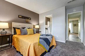 Colorado Springs apartment for rent - Bedroom with a bed and a door to a bathroom  at Union Heights Apartments, Colorado Springs, CO
