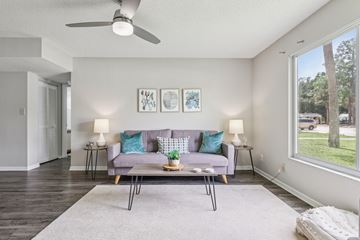 Melbourne apartment for rent - A living room with a grey couch and a grey rug.