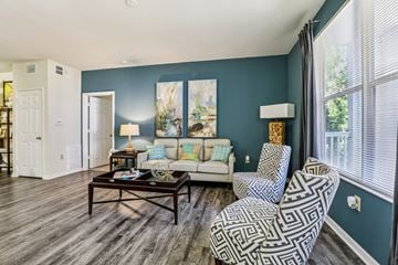 Tampa apartment for rent - A living room with a patterned chair and a coffee table.