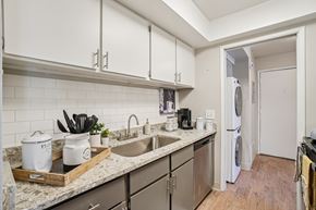 Ogden apartment for rent - A kitchen with a white fridge and a marble counter top.