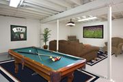 Colorado Springs apartment for rent - A pool table in a room with a TV showing a football game at Aspen Townhomes, Colorado Springs, CO, 80909