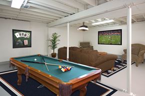 Colorado Springs apartment for rent - A pool table in a room with a TV showing a football game at Aspen Townhomes, Colorado Springs, CO, 80909