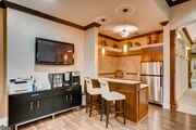 Northglenn apartment for rent - a kitchen with a bar and a refrigerator and a tv at Heritage at Stone Mountain, Northglenn, CO, 80233