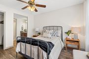 Wilmington apartment for rent - Bedroom with a bed and a ceiling fan at Lofts of Wilmington, Wilmington, NC