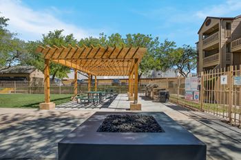 Outdoor patio with a firepit and pergola  
