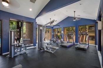 Gym with exercise equipment and windows  