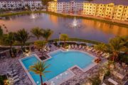 Naples apartment for rent - Sunset Drone View of Buildings, Pool, and Lake at Edge75, Naples, FL 34104
