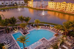 Naples apartment for rent - Sunset Drone View of Buildings, Pool, and Lake at Edge75, Naples, FL 34104