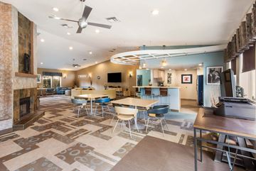 Tempe apartment for rent - a living room with tables and chairs and a fireplace