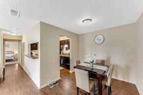 Lewisville apartment for rent - a dining room with a table and chairs and a clock on the wall at The Glen, Texas, 75067