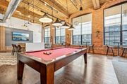 Lawrence apartment for rent - a pool table in an office space with a red pool table at Riverwalk Apartments, Lawrence, MA