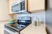 Jensen Beach apartment for rent - a kitchen with a stove and microwave in a 555 waverly unit at Heritage Bay, Jensen Beach, FL 34957