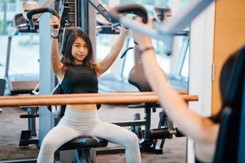 Woman exercising on a machine in a gym
