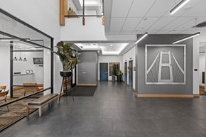 University Place apartment for rent - A modern office space with a glass wall and a bench.