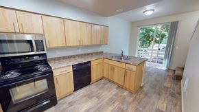 Gig Harbor apartment for rent - a kitchen with wooden cabinets and stainless steel appliances