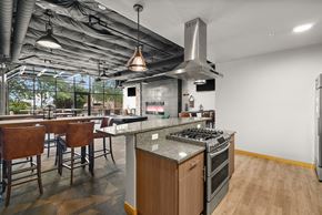 Tacoma apartment for rent - a large kitchen and dining area with stainless steel appliances and counter tops