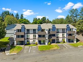 University Place apartment for rent - an aerial view of an apartment building with a parking lot and grass