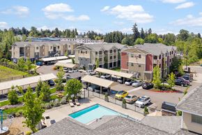 Edgewood apartment for rent - an aerial view of a pool and apartments in a parking lot