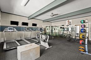 Lacey apartment for rent - a gym with treadmills and weights and a table