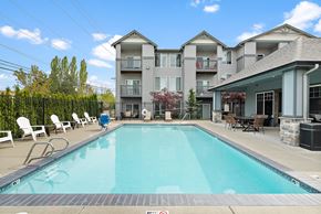 Port Orchard apartment for rent - a swimming pool with a building in the background