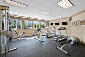 Port Orchard apartment for rent - gym with exercise equipment and windows at the citizens apartments oh