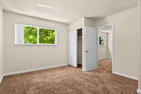 Olympia apartment for rent - an empty bedroom with a closet and a window