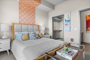 Tacoma apartment for rent - a bedroom with a large bed and a mirrored closet