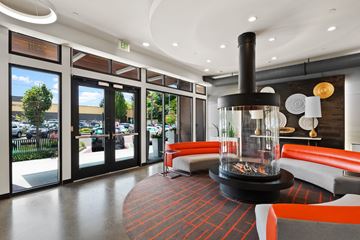 Tacoma apartment for rent - a living room with a fireplace and orange furniture