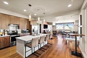 Tacoma apartment for rent - an open kitchen and dining room with a large island and chairs