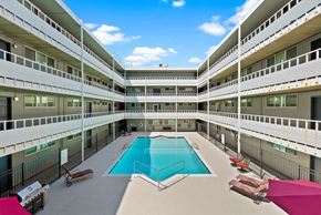 Tacoma apartment for rent - an exterior view of a large building with a swimming pool