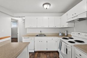 Tacoma apartment for rent - a kitchen with white appliances and counters and white cabinets
