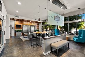 Tacoma apartment for rent - the preserve at ballantyne commons clubhouse with a bar and tables with chairs