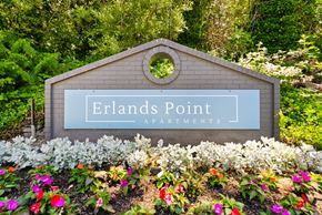 Bremerton apartment for rent - a sign that says rentals point apartments in a garden with flowers