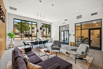 Seattle apartment for rent - A modern living room with a large couch and a coffee table.
