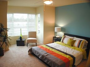 Gig Harbor apartment for rent - a bedroom with a bed and a chair and a window