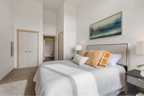 University Place apartment for rent - A bedroom with a large bed and a painting on the wall.