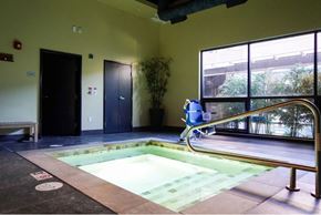 University Place apartment for rent - A small indoor pool with a metal railing.