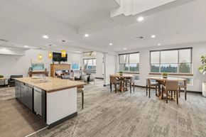 University Place apartment for rent - A modern kitchen with a dining table and chairs.