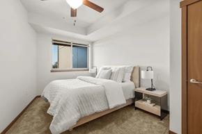 University Place apartment for rent - A bedroom with a bed, nightstand, and window.