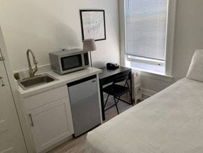 San Francisco apartment for rent - a small kitchen with a microwave and a sink in a bedroom