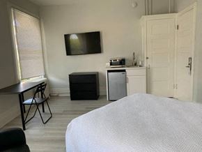 San Francisco apartment for rent - a bedroom with a bed and a sink and a television