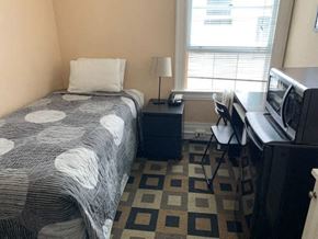 San Francisco apartment for rent - a small bedroom with a bed and a television