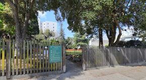 San Francisco apartment for rent - a park with a fence and trees and a sign
